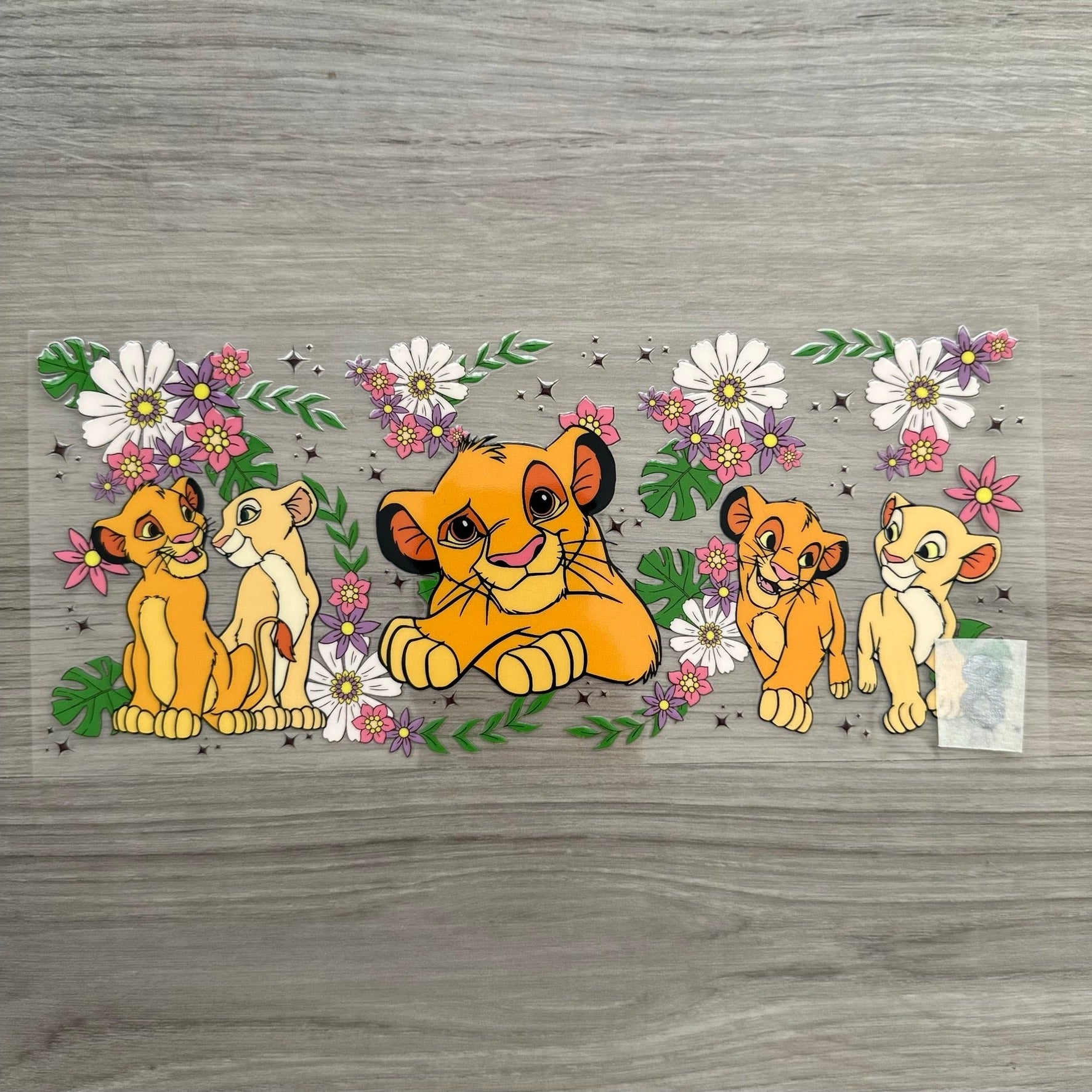 A Simba and Nala wrap with flowers and leaves on it